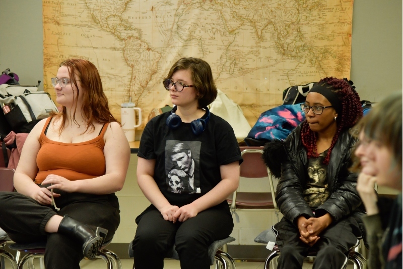 5 Jackson Preparatory & Early College students assembled in a circle during a class listening to their teacher.