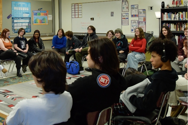 Jackson Preparatory & Early College students sit in a large circle listening to a teacher’s presentation.