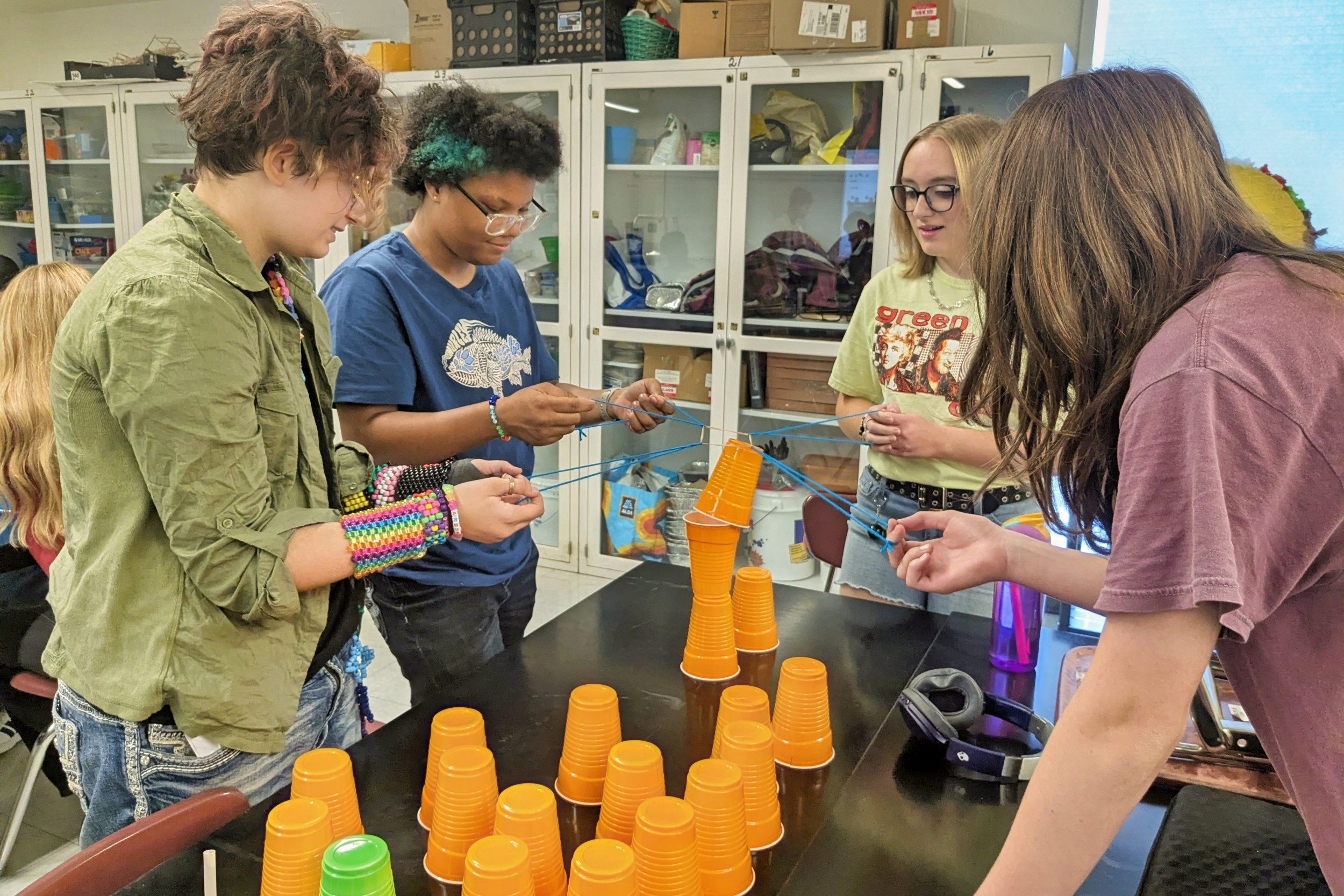 students stacking orange cups