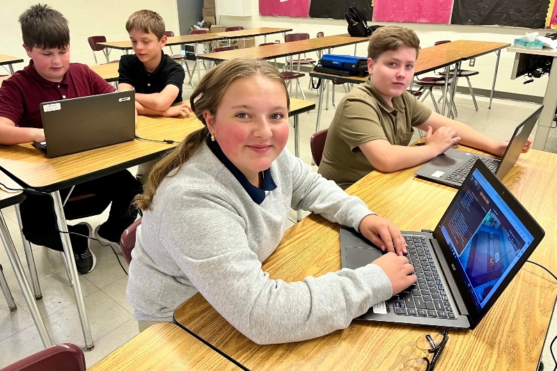 4 Jackson Preparatory & Early College middle schoolers – 3 boys and 1 girl -- work on school issued laptop computers.