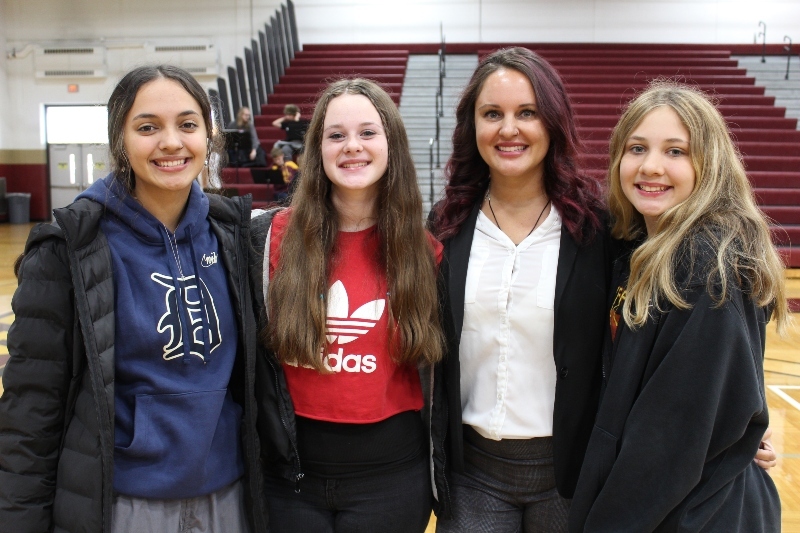 4 Jackson Preparatory & Early College female high school students stand together in front in a school corridor.