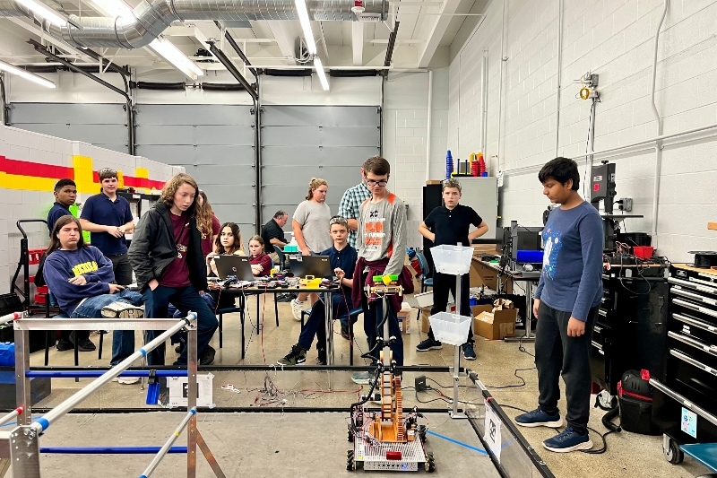 Members of the Jackson Preparatory & Early College robotics team work together to control their robot.