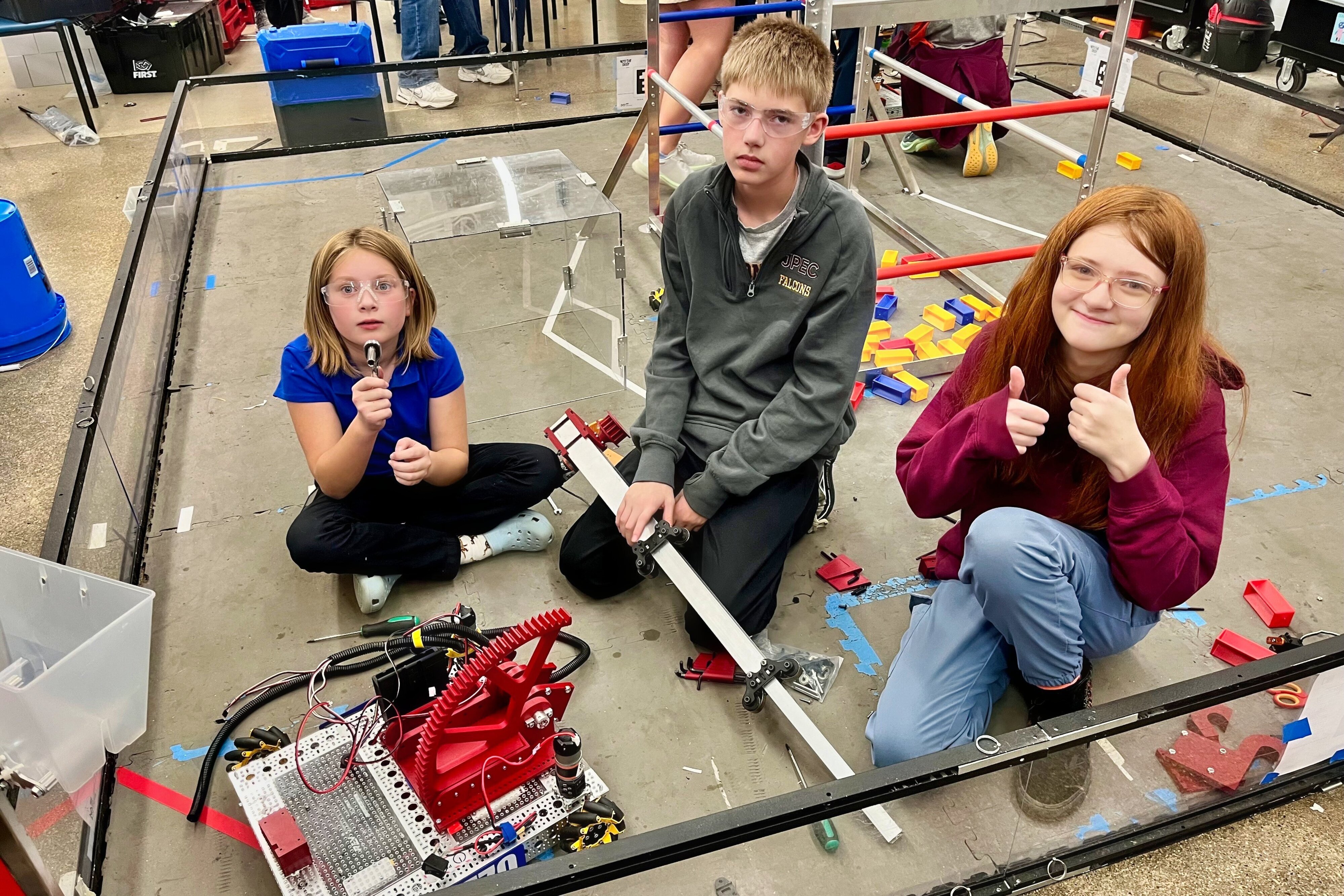 3 Jackson Preparatory & Early College middle schoolers preparing for a robotics competition.