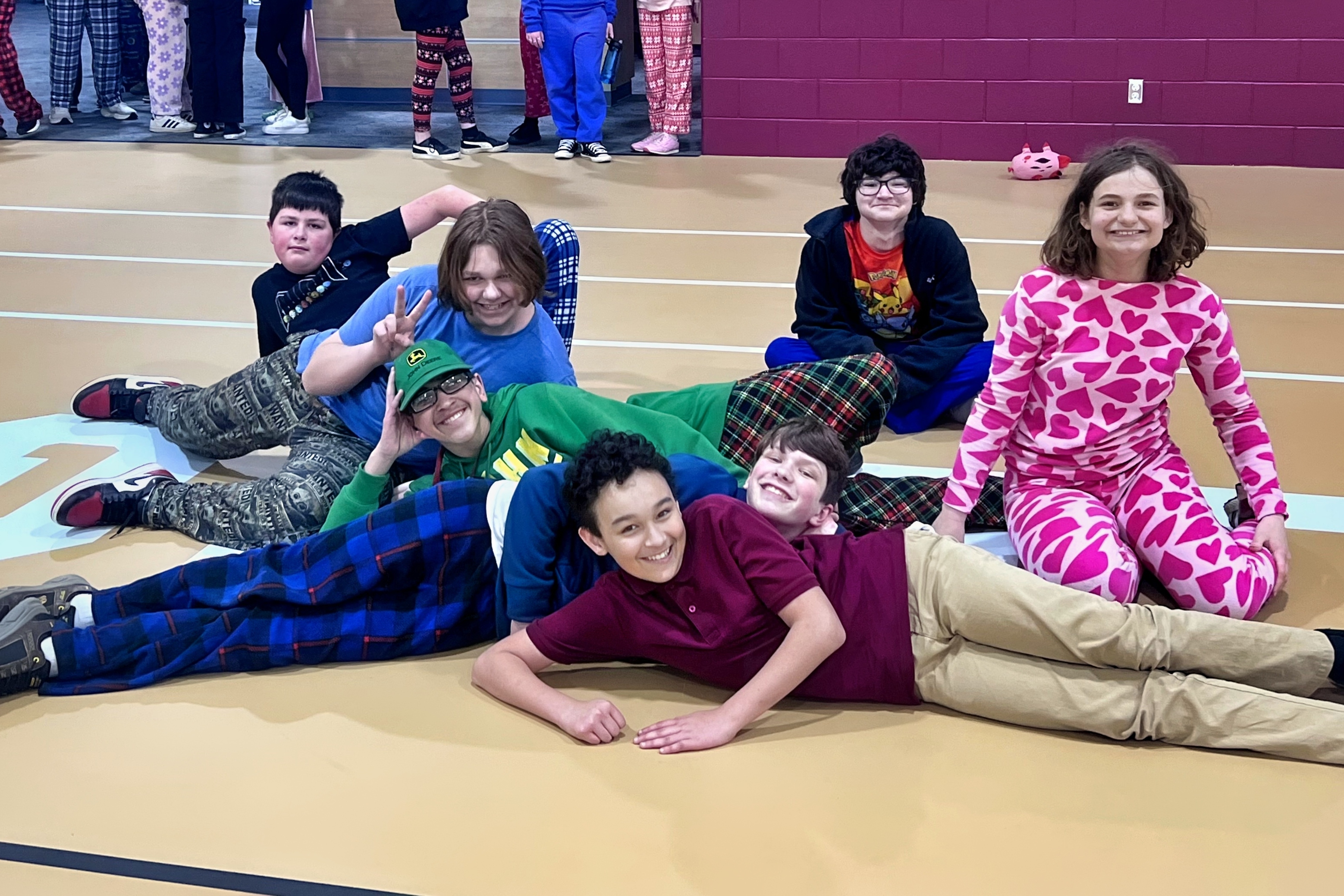 7 Jackson Preparatory & Early College middle school students hanging out in the middle of the Jackson College gym.