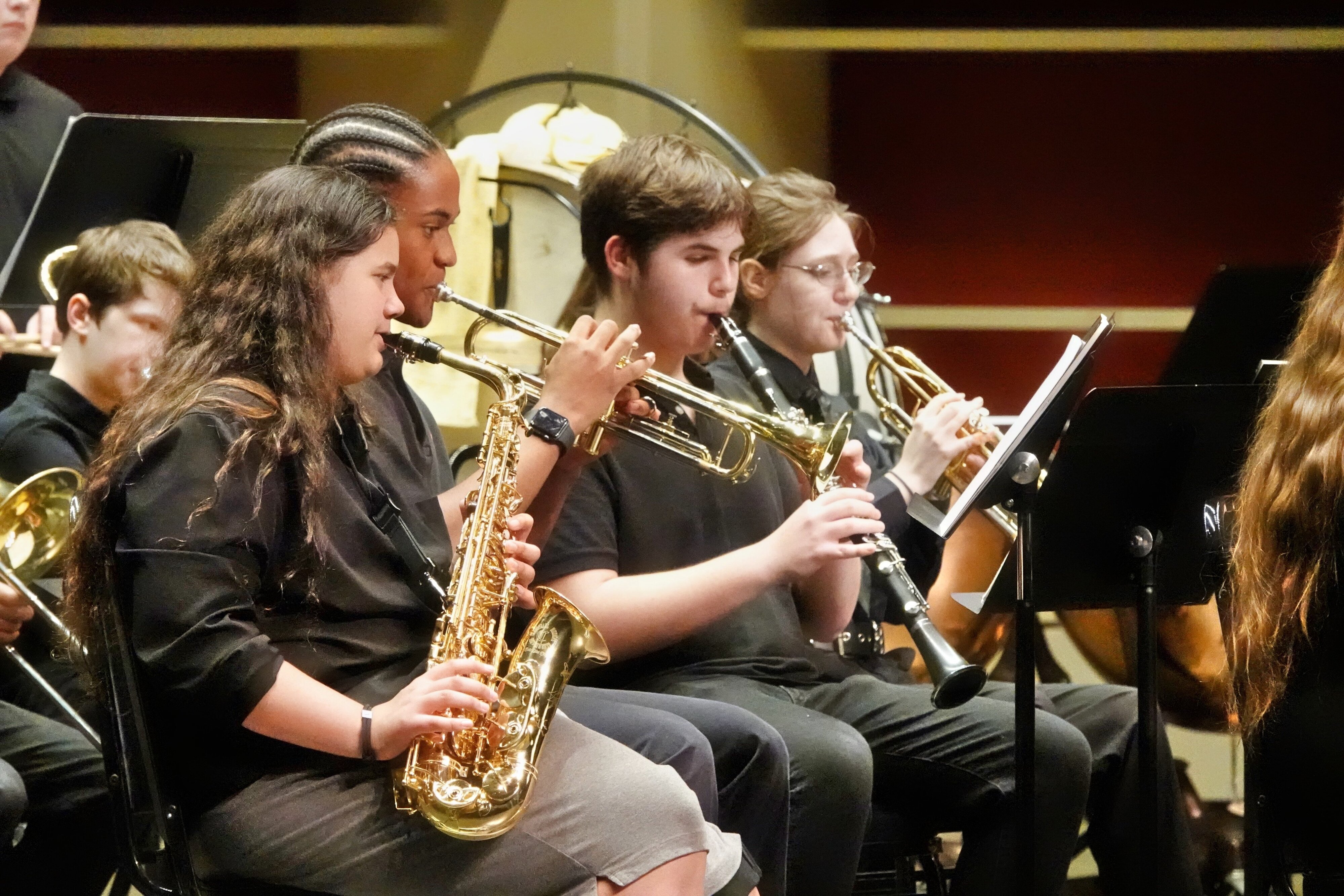Jackson Preparatory & Early College students playing instruments including saxophone, trumpet, and clarinet during the Spring concert.